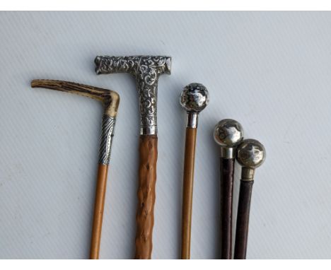 Two Royal West African Frontier Force R.W.A.F.F. Kumasi leather covered wooden shafted swagger sticks, each 68 cm; another ma