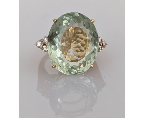 A oval-cut prasiolite and white sapphire dress ring on a yellow gold claw setting, the faceted cushion-cut prasiolite approxi