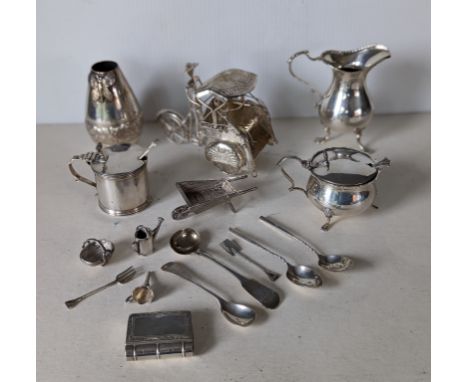 An Edwardian silver mustard pot on cabriole feet by Matthew John Jessop, Birmingham, 1905; another George V; a silver cream j