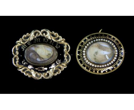 Two Victorian black enamel mourning brooches, one central hair panel surrounded by a fresh water pearl frame, reverse engrave