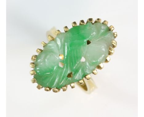 Jade ring,carved bird and fruit motif, tapering shank, mount stamped 18 ct and marked Jayem, ring size M .     CONDITION