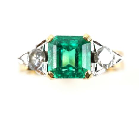 Emerald and diamond ring, with central step cut emerald of  2.02  carats, two brilliant cut diamonds, estimated total weight 