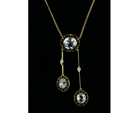 Edwardian negligee pendant set with oval faceted light blue sapphires; featuring central sapphire with a pierced openwork sur