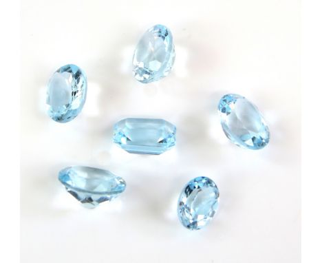 Six loose blue topaz gemstones, one rectangular step cut estimated weight 5.96 carats, and five oval cut stones, estimated we