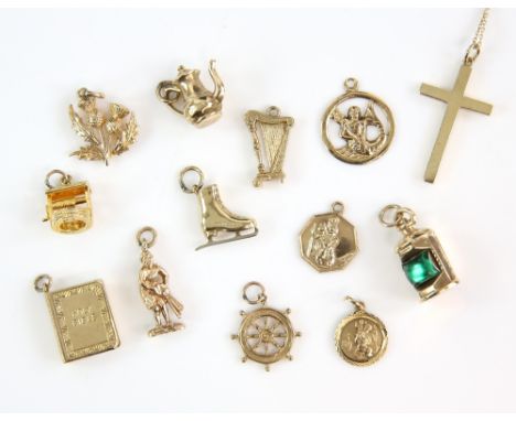 Group of twelve gold charms, including  thistles, well, bible, teapot, ice skate, lamp, harp, figure, Neptune, ships wheel an