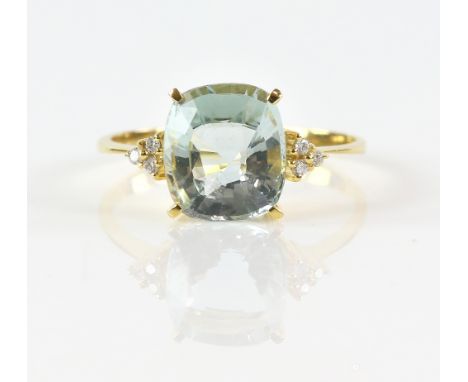 Aquamarine and diamond ring; central oval faceted aquamarine flanked either side by three round cut diamonds set in a triangl