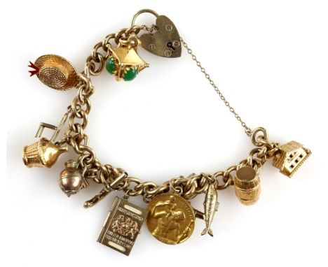 Gold charm bracelet, curb links with heart padlock clasp, hallmarked 9 ct, with fourteen charms, including a lantern, barrel 