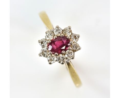 A ruby diamond cluster ring, mounted in 18 ct, ring size O and a pair of round brilliant cut diamond stud earrings, estimated