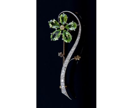 Vintage flower spray brooch set with fancy yellow and white diamonds and pear cut peridot stones, clasp marked '18k' for 18 c