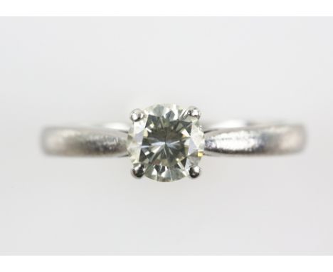 Diamond solitaire ring, with a brilliant cut stone  estimated at  0.75 carats, mounted in platinum, ring size M.     CONDITIO