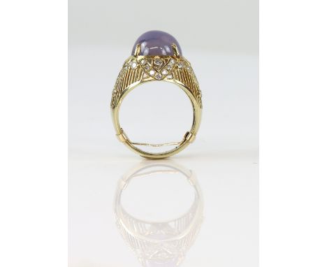 Star sapphire ring, central oval cabochon purplish blue star sapphire, measuring 12.7 x 12.0 x 10.5mm, claw set in open work 