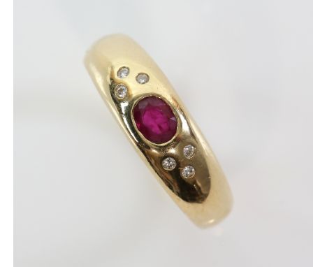 Modern gold  band ring inset with a ruby and six small diamonds, marks for 18 ct gold, ring size M .     CONDITION, good, min