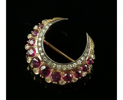 Early 20th C ruby and diamond gold crescent brooch, set with eleven round faceted rubies, the largest estimated at 0.65 carat