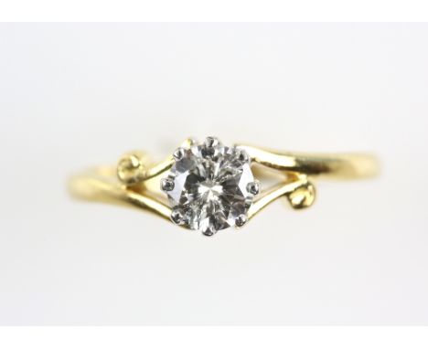 Vintage solitaire  diamond ring set with a single stone estimated 0.50 carat, in 18 ct gold setting, scroll detail to shoulde