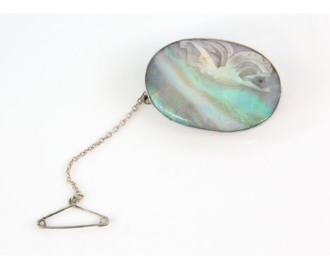Carved opal brooch, depicting flying female figure, set in an engraved mount with lower gallery, testing as 18 ct white gold,