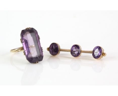 Edwardian three stone bar brooch, set with three oval cut amethysts, pin and catch fitting, 3.5 x 0.8 cm, mounted in 9 ct and