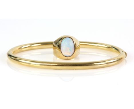 Vintage opal ring, oval cabochon cut opal, mount testing as 9 ct, ring size G 1/2 and a gold oval hinged bangle hallmarked 9 