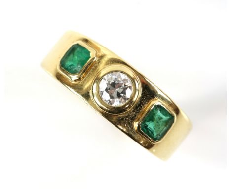 Emerald and diamond three stone ring, centrally set with transitional cut diamond, estimated total weight 0.25 carats, set in