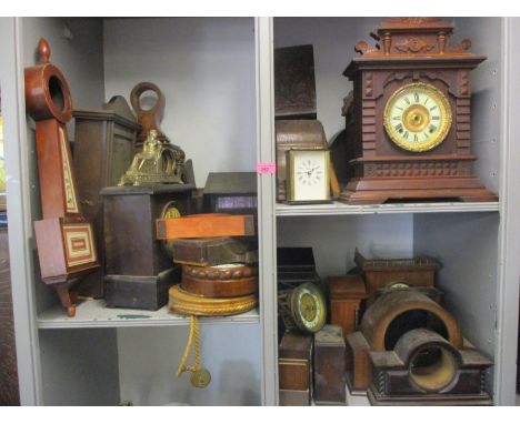 A large selection of Victorian and later clock cases, some with movements 