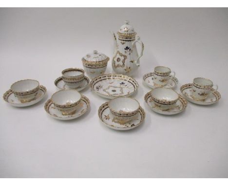 A late 18th century Worcester part teaset decorated with leaves and flower buds in blue and gilt, comprising four tea bowls, 