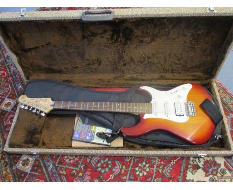 A Yamaha Pacific sunburst colour electric guitar with books and carrying case 