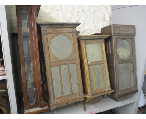 A selection of early 20th century wall hanging clock cases, some with movements 