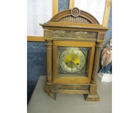 A late 19th century oak cased 8 day mantle clock, having a gilt dial with a silvered chapter ring 