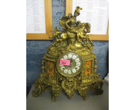A French gilt metal mantle clock having marble plaques depicting a man riding a horse on finial and scrolled legs, fitted wit