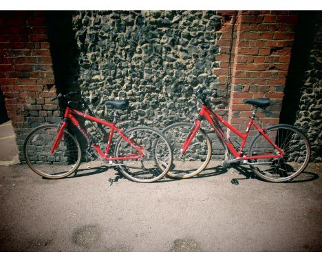 A Cannondale SP300 red coloured bike and a matching ladies bike with owners manual 