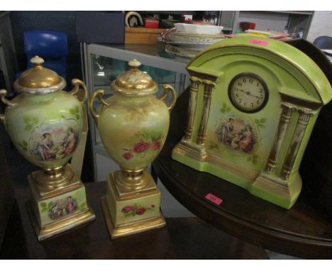 A late 19th/early 20th century porcelain painted mantel clock and a pair of matching vases A/F 