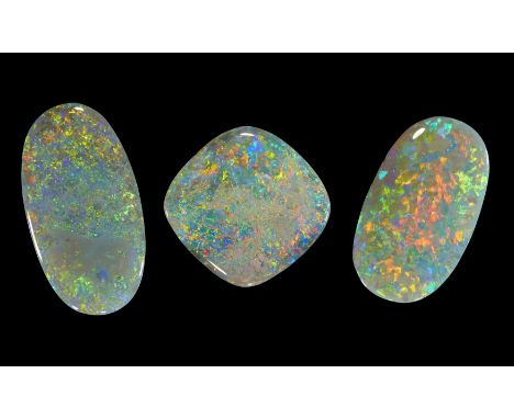 Three unmounted dark/semi-black opals, comprising: an oval opal, 19 x 11 x 4mm, approximately 5.4 carats; an oval opal, 21 x 