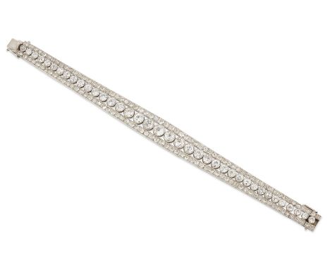 An Art Deco platinum and diamond bracelet, the central row of graduated brilliant cut diamonds between rows of single cut dia