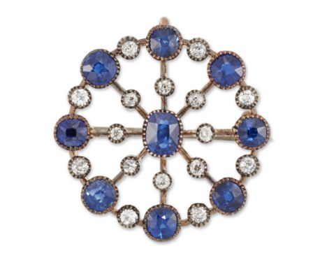 A sapphire and diamond circular brooch, a central oval mixed cut sapphire with radiating knife edge wires collet set with mix