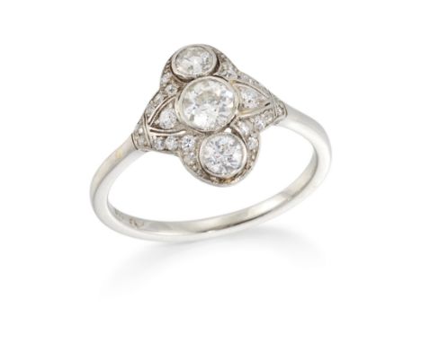 A diamond three stone panel ring, with three graduated old European cut diamonds bezel set to a quatrefoil panel, pavé set wi