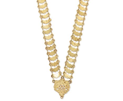A gold neck chain, with pierced scroll panel to shaped panel links joined by pairs of figure of eight links, approximate leng