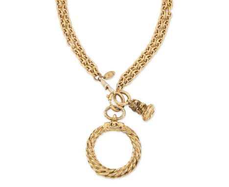 Chanel. A magnifying glass necklace, the gilt metal mounted glass loupe pendant on two row trace link chain, circa 1980, stam