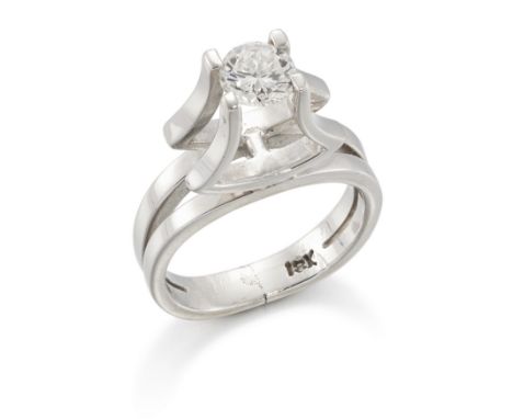 A single stone diamond ring, with a brilliant-cut diamond four claw set to a high collet, to split shoulders and a two row ho