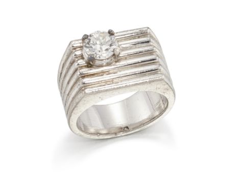A diamond set panel ring, the rectangular reeded head claw set to one corner with a brilliant-cut diamond, to tapering reeded