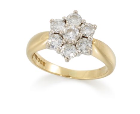 An 18ct gold diamond seven stone ring, of cluster design, with brilliant cut diamonds set in white gold, to a yellow gold hoo