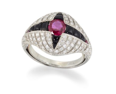 An Art Deco ruby, onyx and diamond ring, the pavé old brilliant cut diamond bombé design bezel with central circular cut ruby