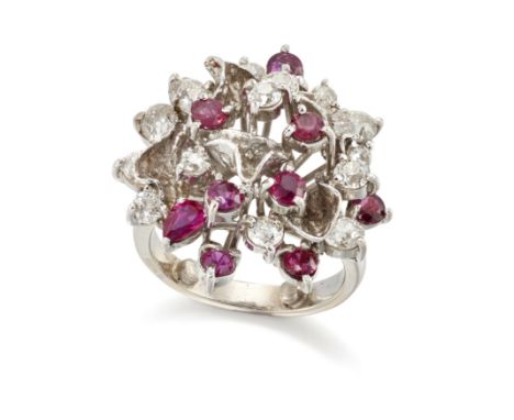 A ruby and diamond cluster ring, the domed head with scattered round and pear mixed-cut rubies and old European-cut and brill