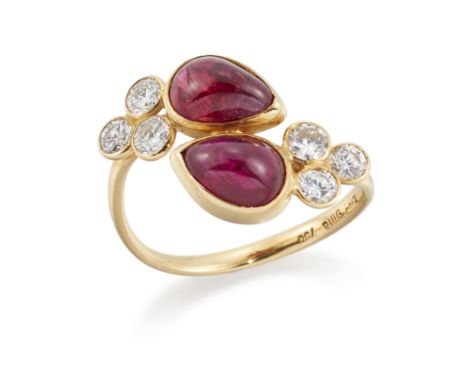 A ruby and diamond crossover ring, with a pair of pear shaped cabochon rubies each with a trefoil of brilliant cut diamonds, 