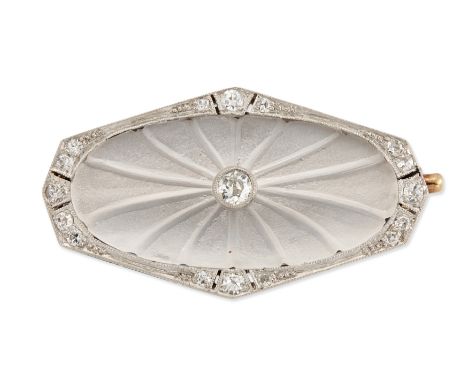 An Art Deco, rock crystal and diamond brooch, the sloped oval rock crystal panel with carved rays and central old brilliant c