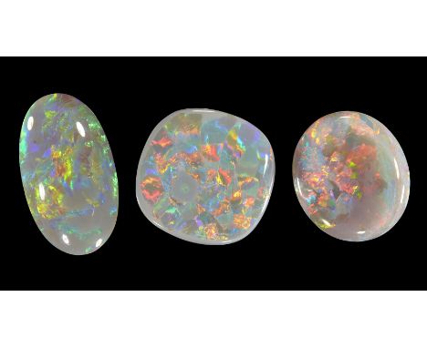 Three unmounted dark/semi-black opals, comprising: one cushion shaped opal, 17 x 17 x 3mm, approximately 6.4 carats; and two 