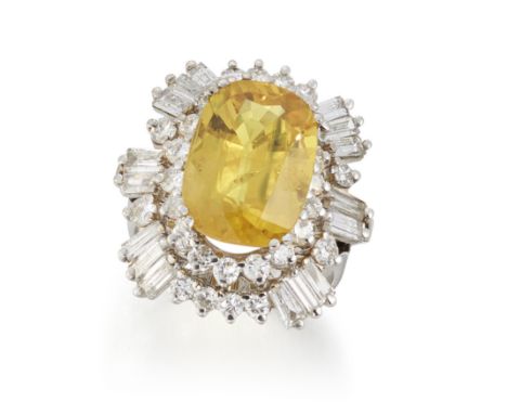 A yellow sapphire and diamond ring,&nbsp;of two row cluster design, with a cushion cut yellow sapphire to border of brilliant