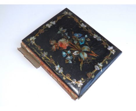 A small black lacquered Victorian papier mache album with mother-of-pearl decoration