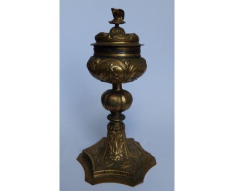 A 17thC gilt copper ciborium, the detachable cover with bird finial, the knopped stem to hexafoil base embossed with dolphin 