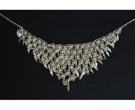 A 1970's Indian silver white metal vintage retro v-shaped multiple string silver white metal necklace. The graduating design 