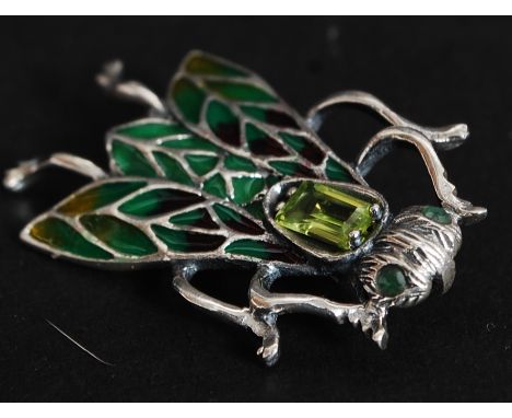 A silver and enamel bug brooch inset with peridot stone. Total weight 4.4g.

FREE UK POSTAGE ON ALL LOTS INCLUDING COMBINED P