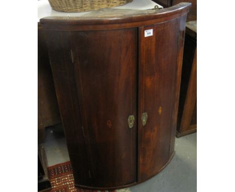 Early 19th Century mahogany inlaid bow fronted blind panelled corner cupboard. (B.P. 24% incl. VAT)